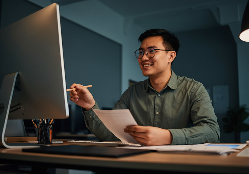 A young designer who looks happy because he feels safe with his team.